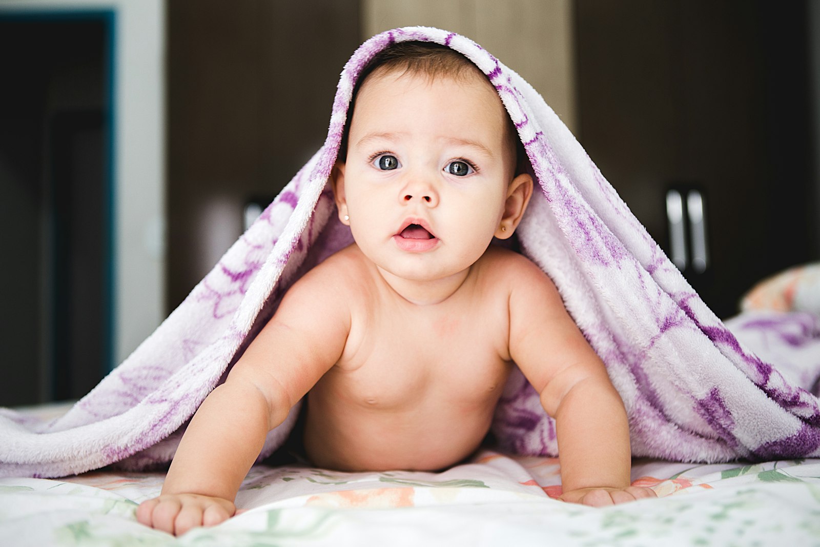 A peaceful newborn sleeping wrapped in a soft blanket.